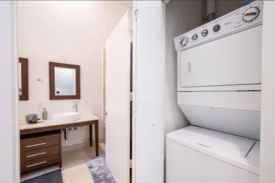 a bathroom with a sink and a white refrigerator at Beautiful One Bedroom Condo 16ft ceilings at the W in Miami