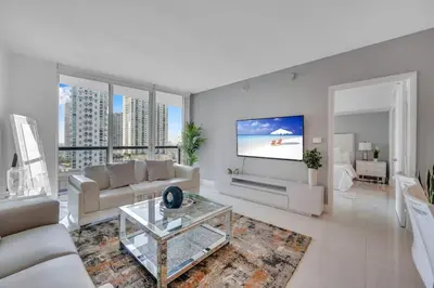 a living room with a couch and a flat screen tv at Modern 1 Bed ICON Brickell with Amazing Views in Miami