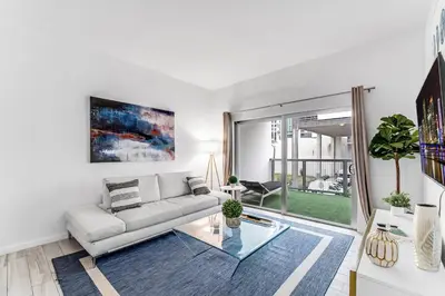 a living room with a couch and a glass table at Lovely Unit Mins from Wynwood with Free Parking in Miami