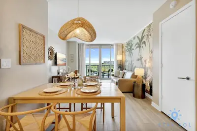 a dining room and living room with a table and chairs at Modern Resort - Balcony - Gym - Amazing Pool in Hallandale Beach