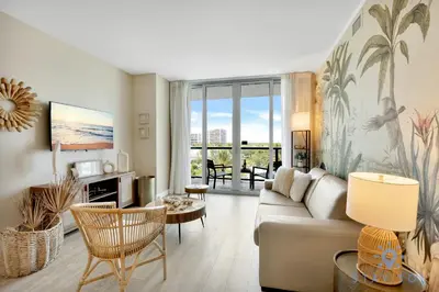a living room with a couch and a table at Modern Resort - Balcony - Gym - Amazing Pool in Hallandale Beach