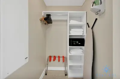 a room with a closet with white shelves at Modern Resort - Balcony - Gym - Amazing Pool in Hallandale Beach