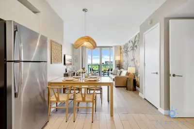 a kitchen and dining room with a table and chairs at Modern Resort - Balcony - Gym - Amazing Pool in Hallandale Beach