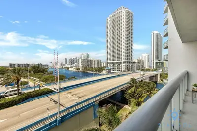 a bridge over a river in a city with tall buildings at Modern Resort - Balcony - Gym - Amazing Pool in Hallandale Beach