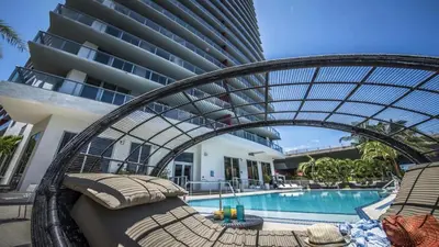 a resort with a swimming pool and a hotel at Modern Resort - Balcony - Gym - Amazing Pool in Hallandale Beach
