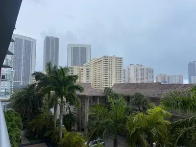 a city skyline with tall buildings and palm trees at Relax by the Sea in This Cozy Beachfront Room 908B in Hallandale Beach