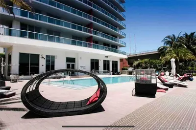 a swimming pool with a large building at Relax by the Sea in This Cozy Beachfront Room 908B in Hallandale Beach