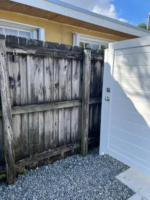 a wooden fence in front of a house at Stunning Deluxe Studio in Hialeah