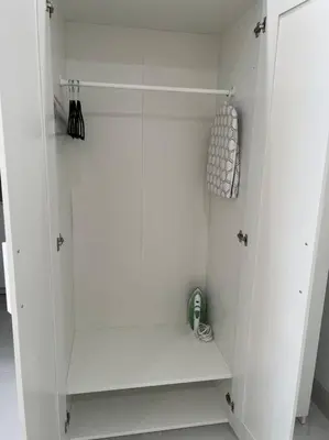 a white walk in shower with a glass door at Stunning Deluxe Studio in Hialeah