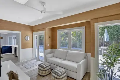 a living room with a couch and a table at Brand New! Heated Pool, Golf Cart, Next to Beach in Fort Lauderdale
