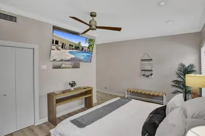 a bedroom with a bed and a ceiling fan at Brand New! Heated Pool, Golf Cart, Next to Beach in Fort Lauderdale