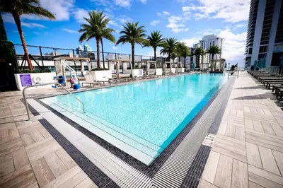 a swimming pool on the roof of a building with palm trees at Diamond In The Sky in Hollywood