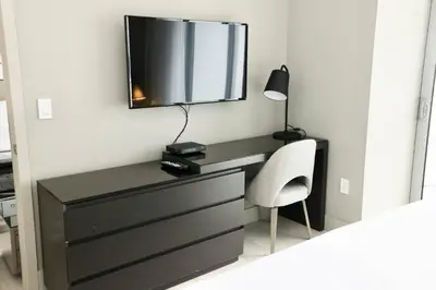 a bedroom with a desk with a mirror and a chair at Diamond In The Sky in Hollywood