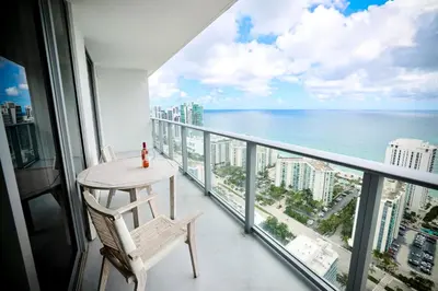 a balcony with a table and chairs and the ocean at Diamond In The Sky in Hollywood