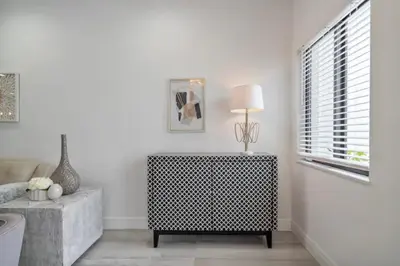 a living room with a table and a lamp and a window at New Townhome near Wilton/Las Olas/Beach in Fort Lauderdale