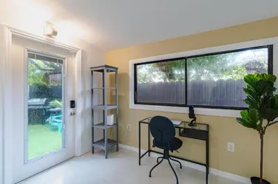 a home office with a desk and a window at Beautiful, fully furnished 2bed 1bath house - 5 minute walk to Miracle Mile Downtown Coral Gables in Miami