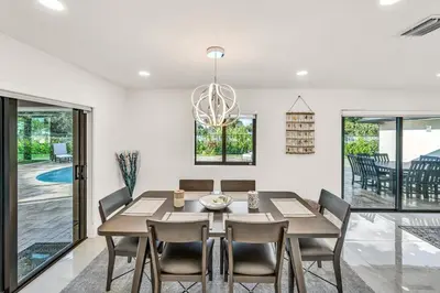 a dining room with a table and chairs at Sandals Beach Cottage in Fort Lauderdale
