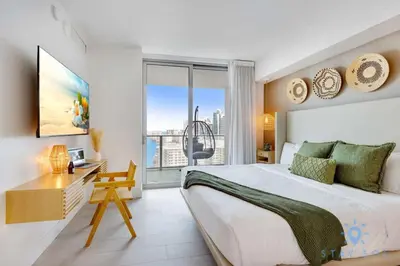 a bedroom with a bed and a desk and a window at Jungle Experience, High Floor, Pools in Hollywood