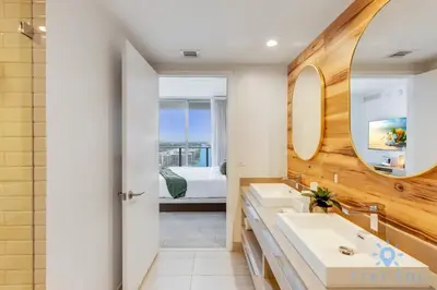 a bathroom with two sinks and a bedroom at Jungle Experience, High Floor, Pools in Hollywood