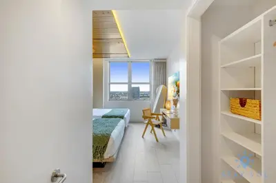 a bedroom with a bed and a desk and a window at Jungle Experience, High Floor, Pools in Hollywood