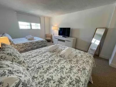 a hotel room with two beds and a mirror at Ocean reserve 702 - STR 2315 in Miami Beach