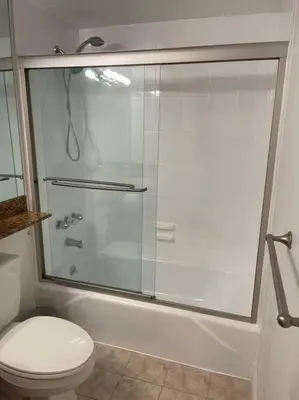 a bathroom with a toilet and a glass shower at Ocean reserve 702 - STR 2315 in Miami Beach