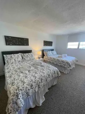 a bedroom with two beds and a window at Ocean reserve 702 - STR 2315 in Miami Beach