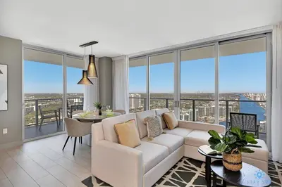 a living room with a couch and a table at HighFloor with Stunning Views, Pools, Near Beach in Hollywood