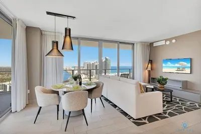a living room with a table and chairs and a couch at HighFloor with Stunning Views, Pools, Near Beach in Hollywood