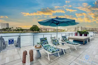 a patio with a table and chairs and an umbrella at HighFloor with Stunning Views, Pools, Near Beach in Hollywood