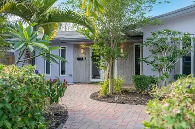 a home with a brick walkway in front of a house at Hollys Hacienda with Heated Pool and Patio Area in Hollywood