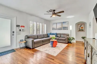 a living room with a couch and a ceiling fan at Victoria Park Oasis with Heated Pool and More in Fort Lauderdale