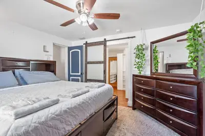 a bedroom with a large bed and a ceiling fan at Wileys Paradise Three Bedroom Two Bath plus Office and Heated Pool in Hollywood