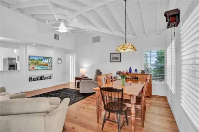 a dining room and living room with a table and chairs at Chic Victoria Park Villa with Heated Pool and Spa in Fort Lauderdale