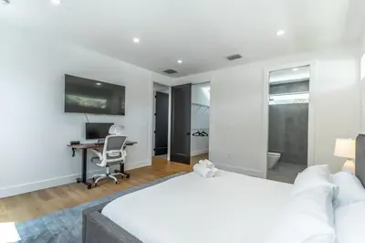 a bedroom with a bed and a desk with a computer at Lux Villa with Pool, Wynwood House by RoveTravel in Miami