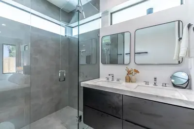 a bathroom with two sinks and a glass shower at Lux Villa with Pool, Wynwood House by RoveTravel in Miami