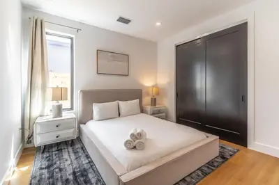 a bedroom with a bed with two stuffed animals on it at Lux Villa with Pool, Wynwood House by RoveTravel in Miami