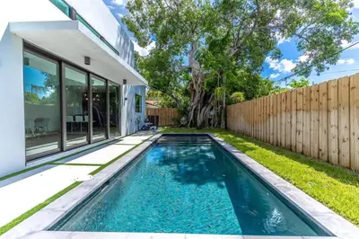 a swimming pool in the backyard of a house at Lux Villa with Pool, Wynwood House by RoveTravel in Miami