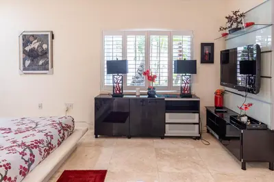 a bedroom with a bed and a flat screen tv at Oceana Blue / Beach Front / Pool / Bar / Relax in Fort Lauderdale
