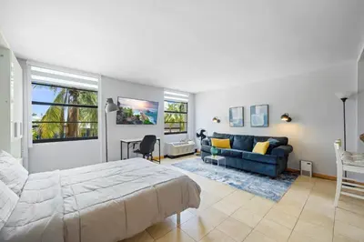 a bedroom with a bed and a couch at Cozy studio, walk to the beach, restaurants, bars in Miami Beach