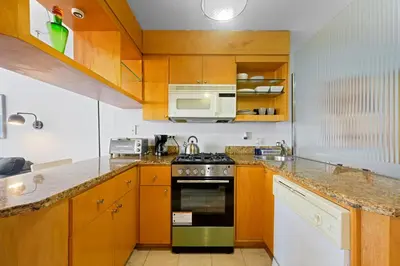 a kitchen with a stove and a microwave at Cozy studio, walk to the beach, restaurants, bars in Miami Beach