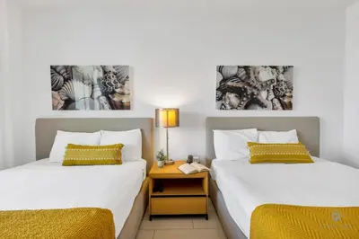 two beds sitting next to each other in a room at Amazing Pool - Balcony - Gym - Near Beach in Hallandale Beach