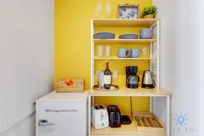 a kitchen with yellow walls and a white refrigerator at Amazing Pool - Balcony - Gym - Near Beach in Hallandale Beach