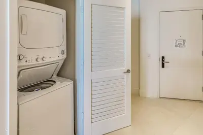 a washer and dryer in a white laundry room at Ocean Front Paradiiise 3 Bedroom by Zen in Hollywood