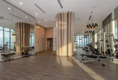 a gym with treadmills and exercise equipment in a building at Ocean Front Paradiiise 3 Bedroom by Zen in Hollywood