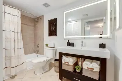 a bathroom with a sink and a toilet and a tub at Elegant 1BR APT w balcony and stunning bay view in Miami