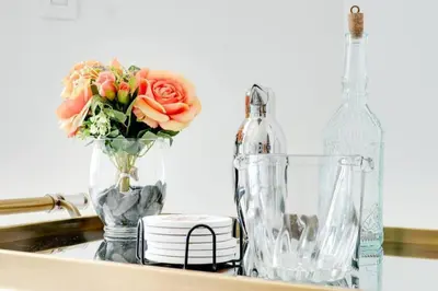 a vase of flowers and a bottle on a sink at Penthouse APT w Private Balcony King Bed Parking in Miami