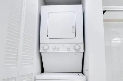 a white refrigerator freezer sitting in a kitchen at Penthouse APT w Private Balcony King Bed Parking in Miami