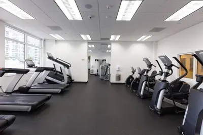 a gym with rows of treadmills and cardio machines at Penthouse APT w Private Balcony King Bed Parking in Miami