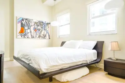 a bedroom with a bed and a painting on the wall at Ocean view Work from Home Balcony Parking Pool in Miami